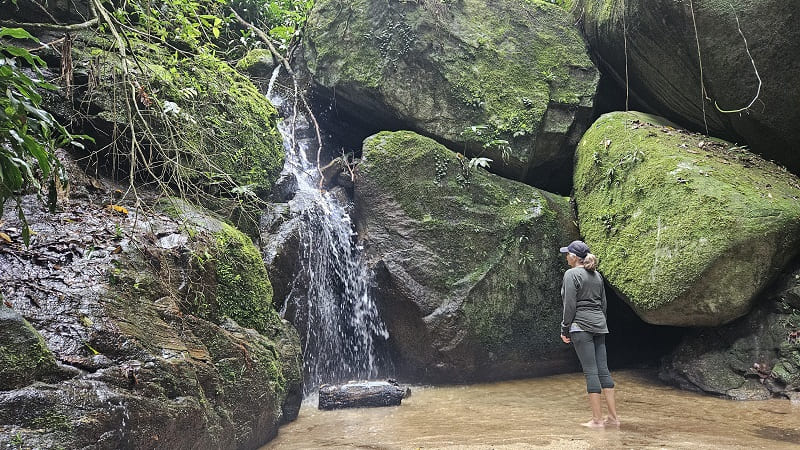 woman admiring waterfall at tijuca national park